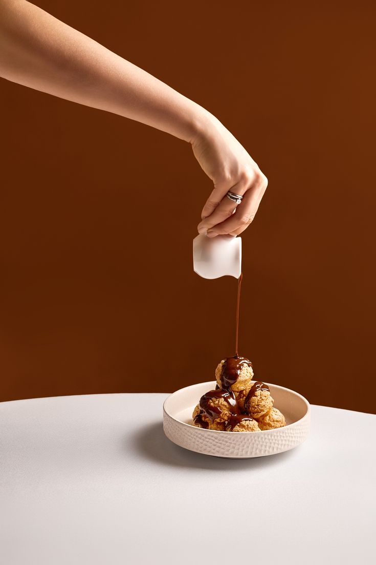 Chocolate sauce poured over choux pastry